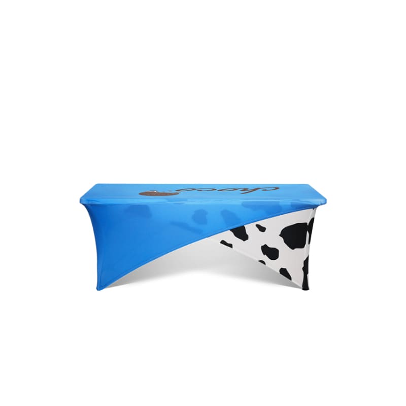 A blue and black cow-print stretch tablecloth designed for a 4ft table. It features a logo. Cross-over Stretch Table Cloth * 4ft - Image 1