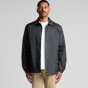 A black coach jacket with a front snap closure and a relaxed fit, featuring a logo on the chest.