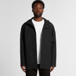 A black rain jacket with a hood, featuring a front zip and snap closure, modelled by a person.