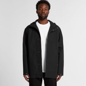 A black rain jacket with a hood, featuring a front zip and snap closure, modelled by a person.