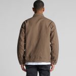 A heavy canvas jacket in brown, featuring a simple design and a logo on the back.
