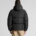 A hooded puffer jacket in black, featuring a plush design and a rear view displaying the hood and quilting.