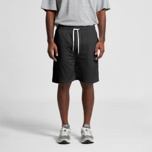Black sports shorts with a drawstring waist, worn by a person in a grey t-shirt and grey trainers.