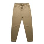 A pair of beige track pants with an elastic waistband and cuffs, featuring a drawstring and a logo.