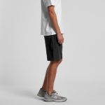 Active training shorts in black, featuring a streamlined design, worn by a person in grey sneakers and a white t-shirt.
