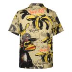 A short-sleeve shirt featuring a yellow pattern with bananas and a monkey graphic, adorned with various artistic elements.