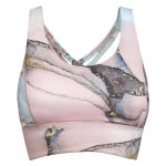 A cropped tank top in pastel pink with abstract blue and gold designs, featuring a cross-back style and a logo.