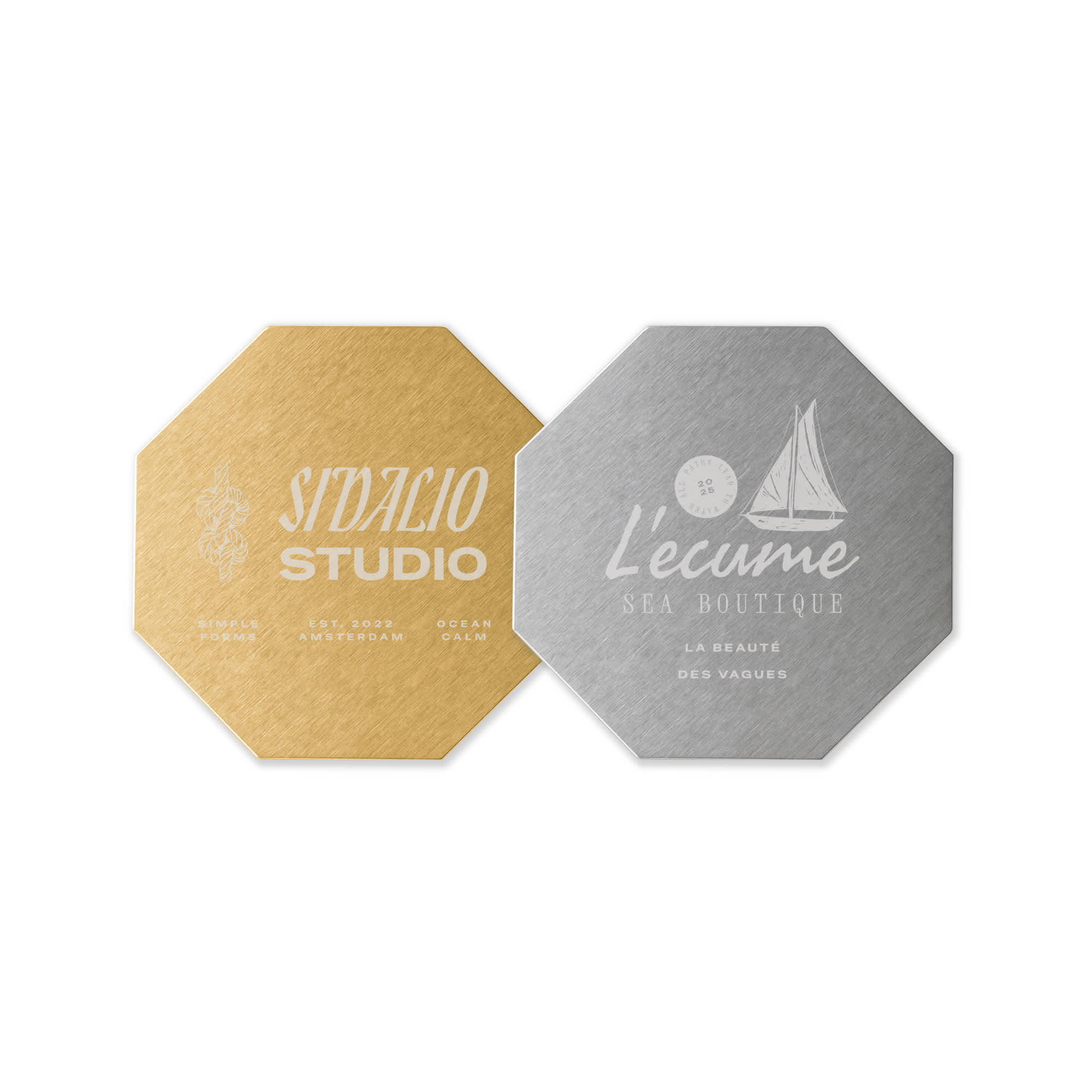 An octagonal metal coaster in gold and silver finishes, featuring logos on each side. Octagonal Metal Coaster - Image 1