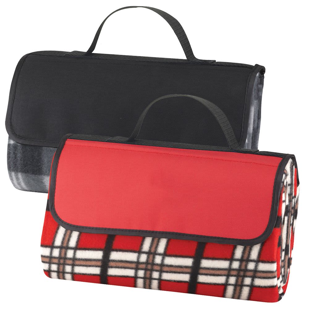 A picnic rug with a red and plaid design, featuring a black carrying handle and foldable design. Picnic Rug - Image 1