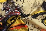 A vibrant fabric featuring a blend of yellow, red, and black patterns, designed for varsity jacket lining.