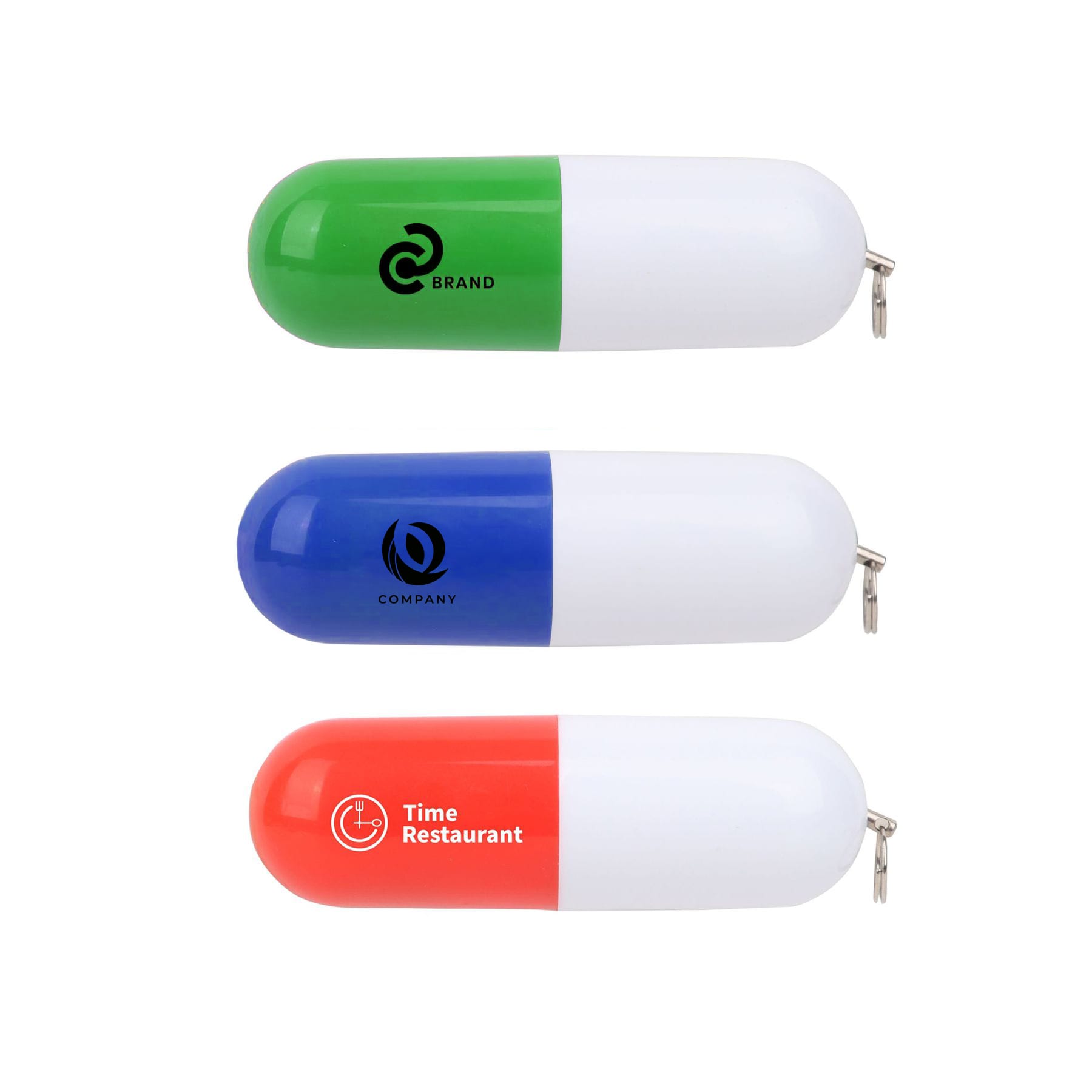 Three pill-shaped flash drives in green, blue, and orange. Each features a logo on a white background. Pill Shaped Flash Drive - Image 1