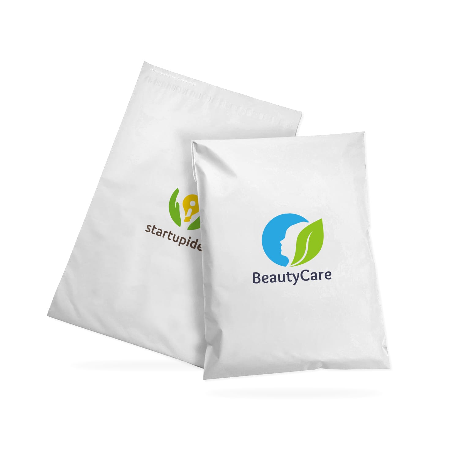 Two medium-sized biodegradable mailer bags in white, featuring logos on the front. Biodegradable Mailer Bag (Medium) - Image 1