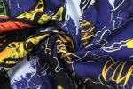 A vibrant purple and multi-coloured fabric featuring bold patterns, designed for sports uniforms with a sublimation lining.