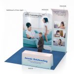 A 2m straight tension fabric display wall in blue and white with product features, a logo, and a table.
