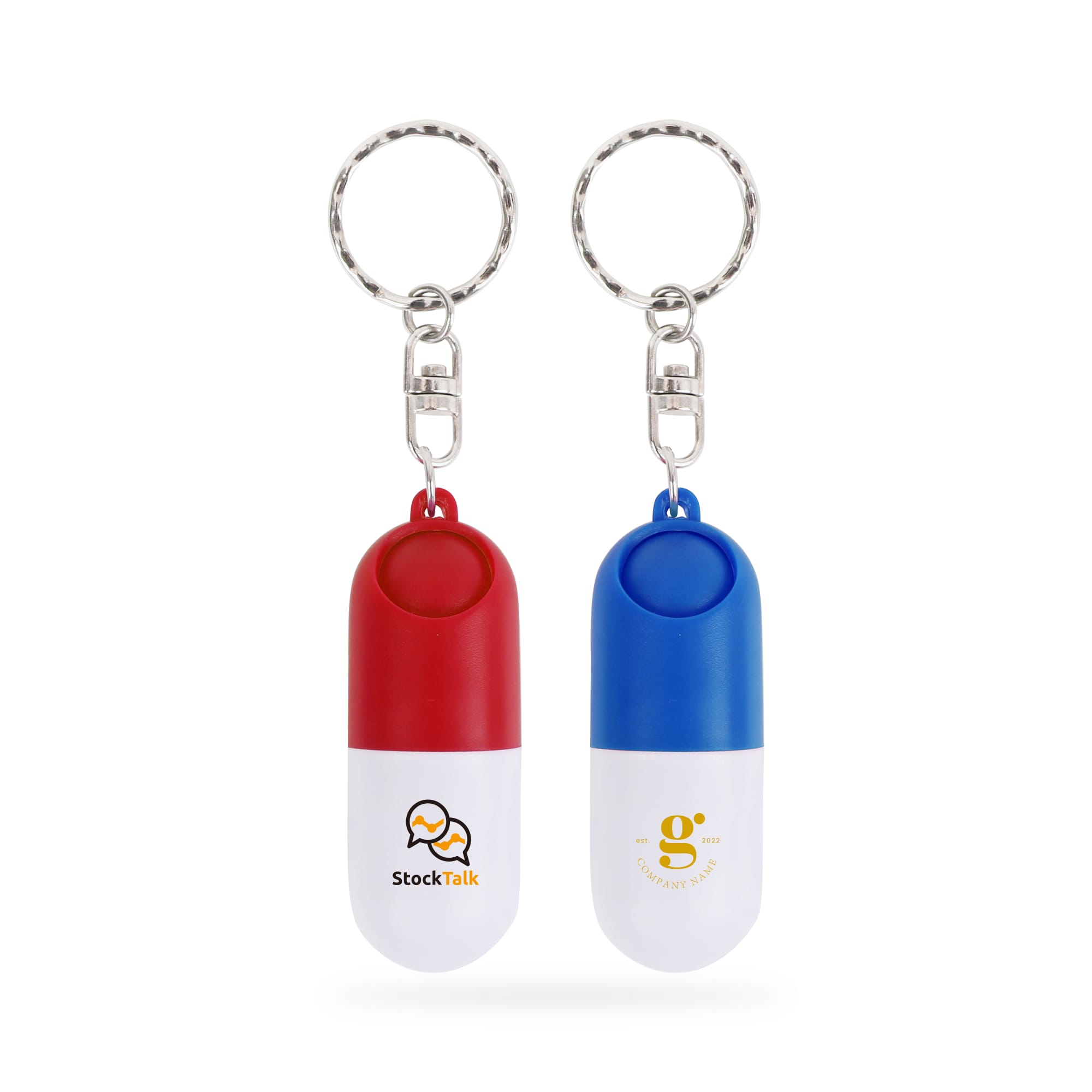 A red and white pill capsule keychain alongside a blue and white pill capsule keychain, both with logos. Pill Capsule Keychain - Image 1