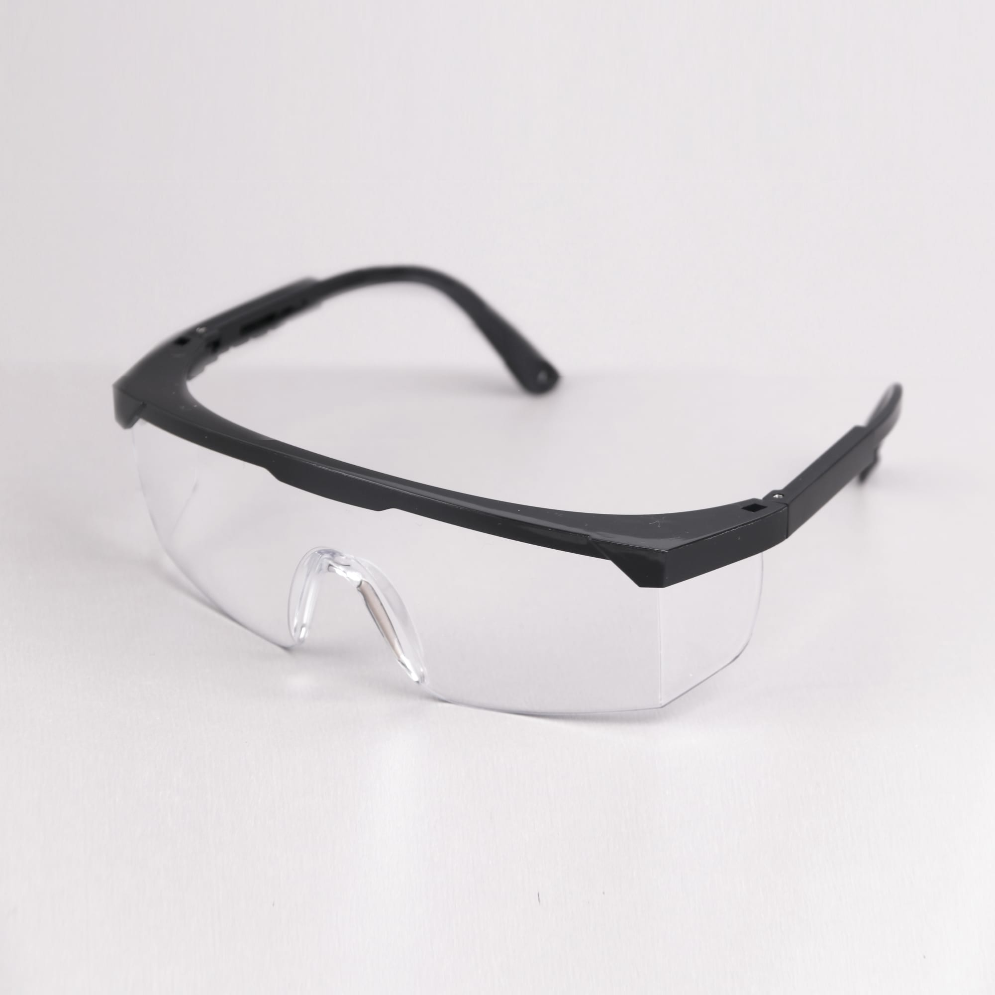 Retractable goggles featuring a black frame and clear anti-fog lenses, with a logo on the side. Anti Fog Retractable Goggles - Image 1