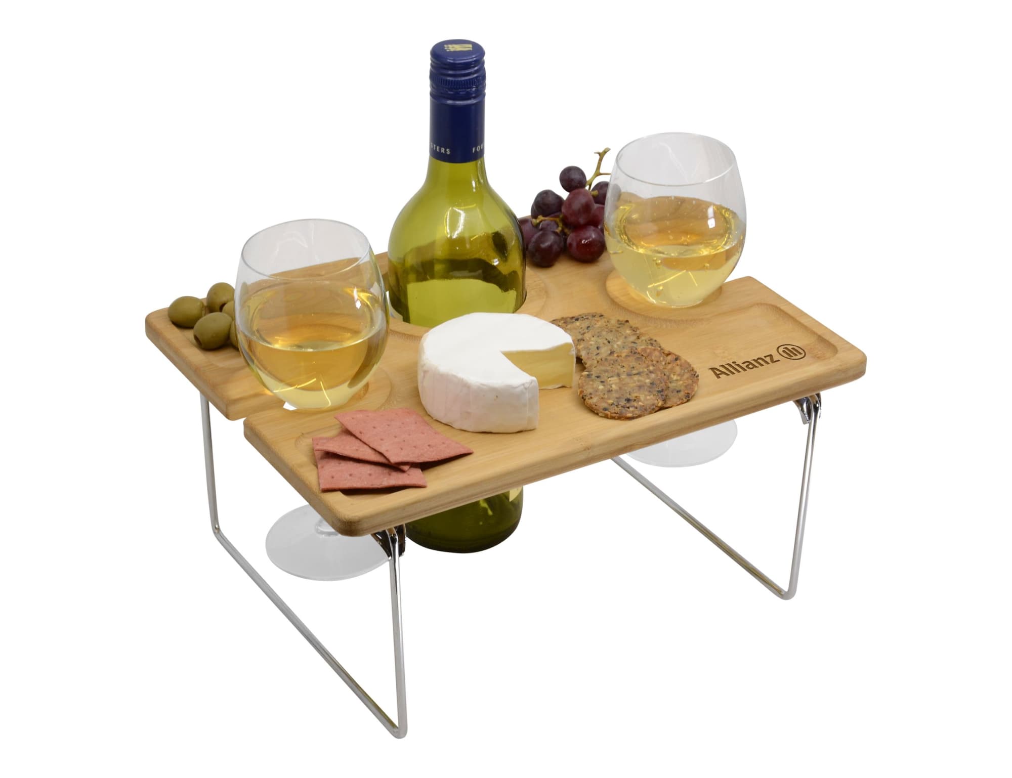 A wooden picnic table with two glasses of white wine, a bottle, cheese, crackers, olives, and grapes. Picnic for Two - Image 1