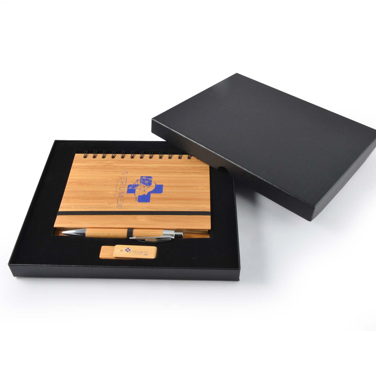A bamboo notebook with a pen and wooden USB drive, presented in a black gift box. The notebook features a branding logo. Sephora Gift Set - Image 1