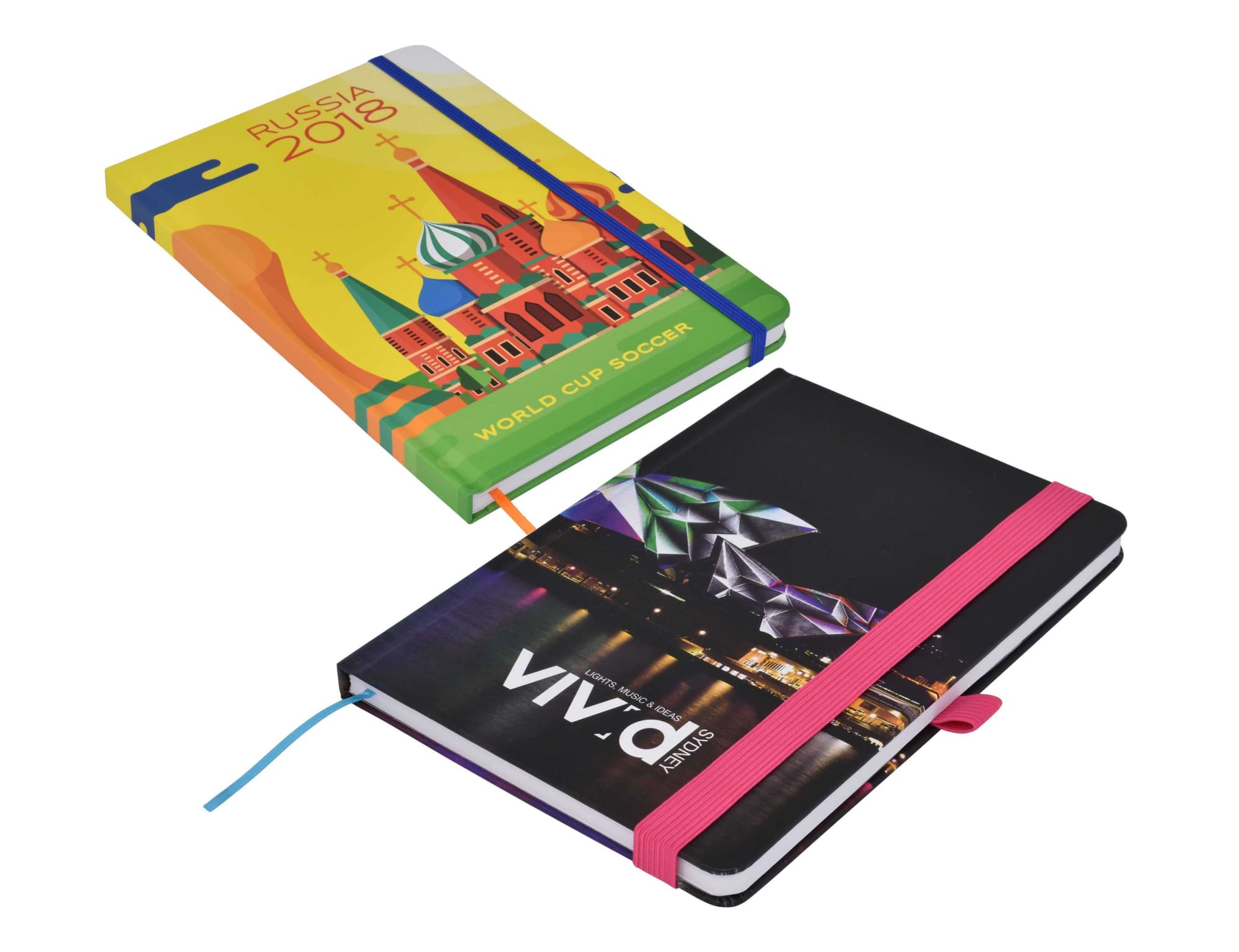 A vibrant, full-colour A5 notebook featuring a design related to Russia 2018 and another with a cityscape, both with elastic bands. Designa Full Colour Matt A5 Notebook - Image 1