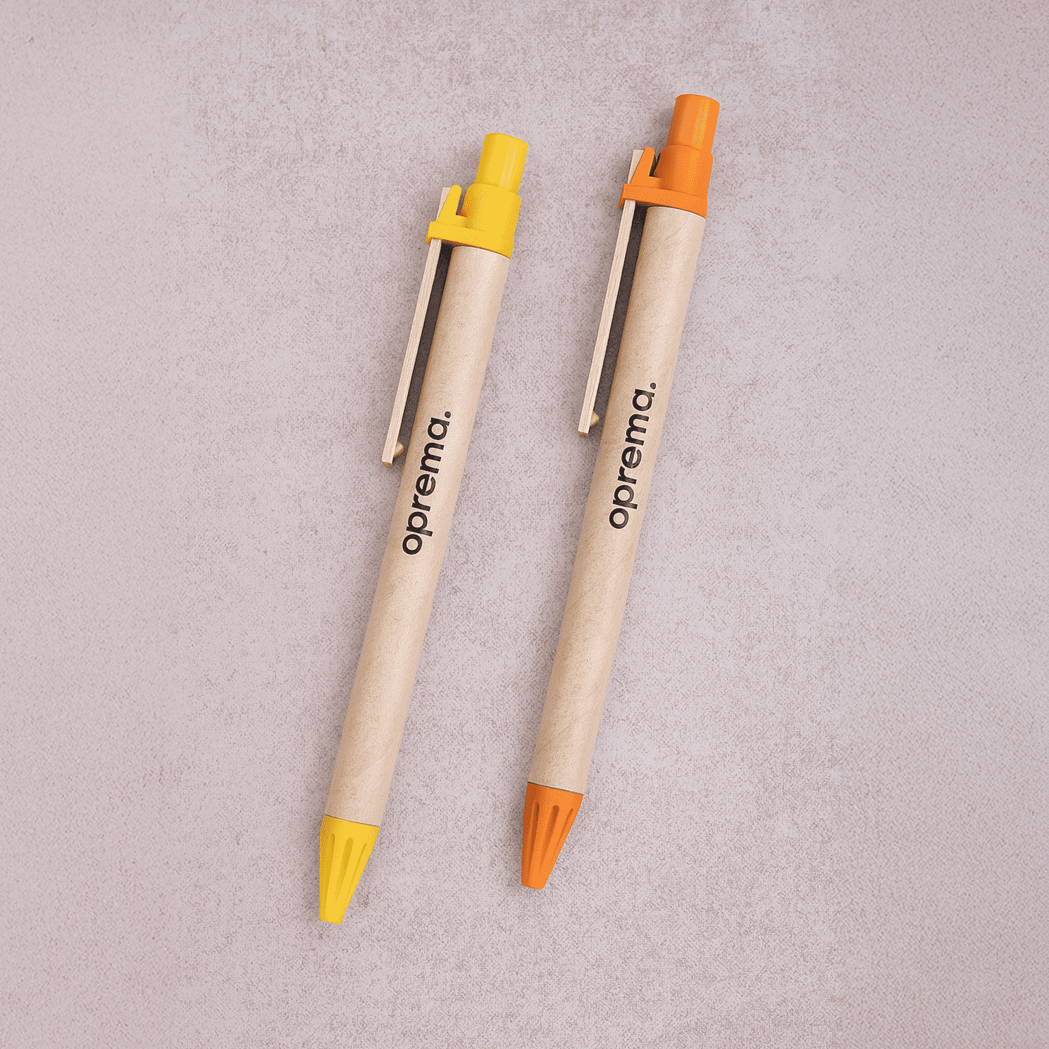 Two wooden pens in yellow and orange with a brand logo on each. Madeira Pen - Image 1
