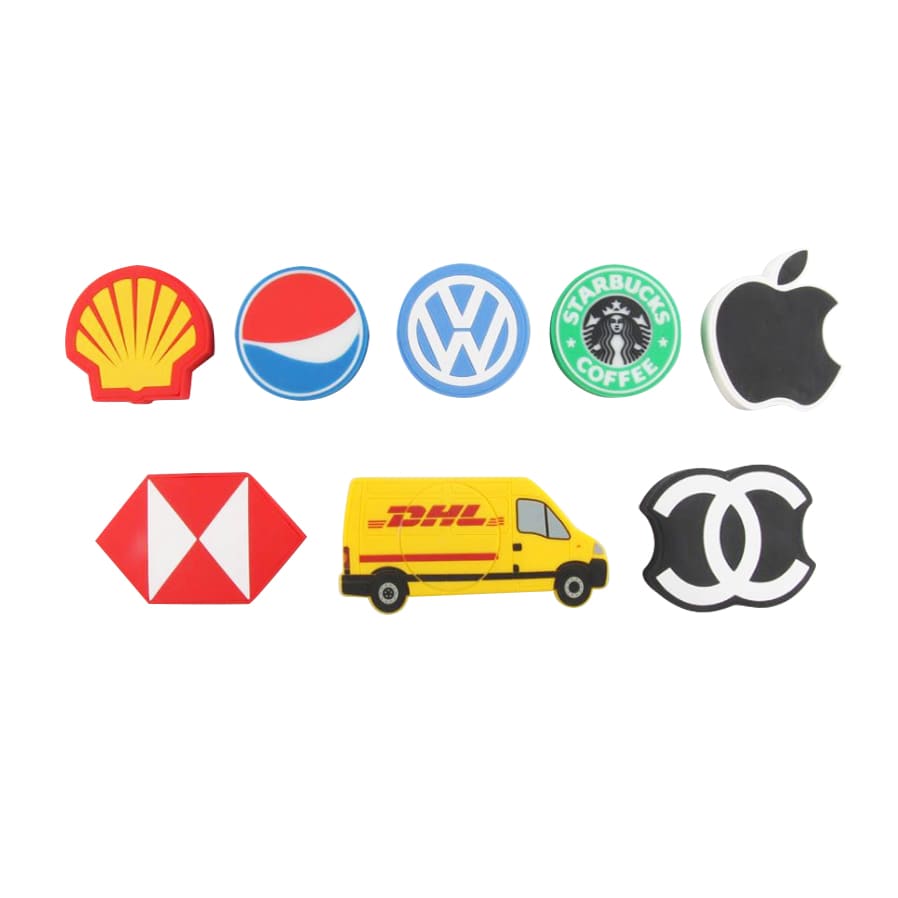 A series of custom-shaped PVC wireless chargers in various designs, featuring logos in red, green, black, yellow, and blue. Custom Shaped PVC Wireless Charger - Image 1