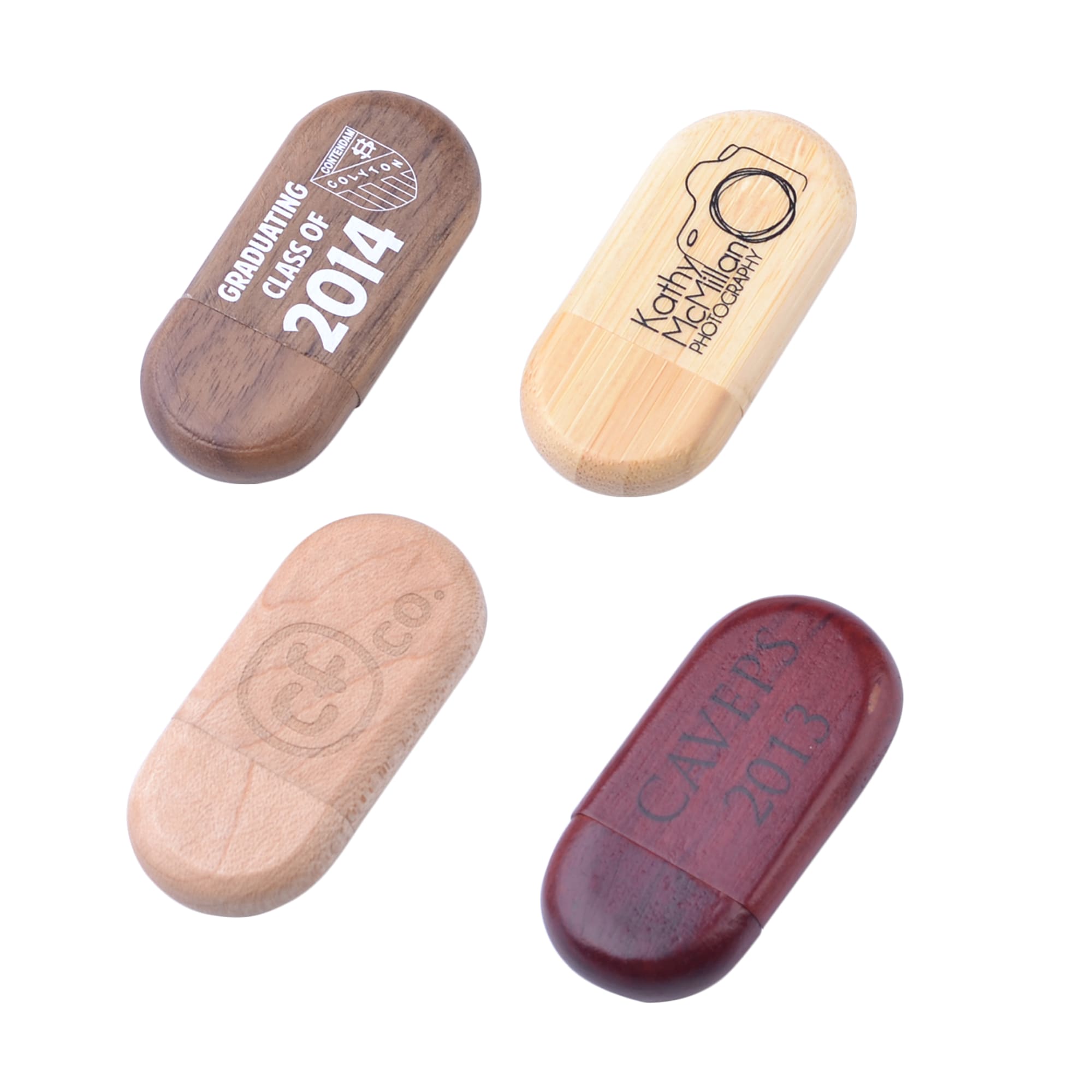 An assortment of oblong wooden flash drives in various finishes, featuring different engravings and a logo. Oblong Wood Flash Drive - Image 1