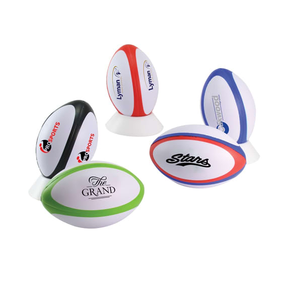 A variety of stress rugby balls in different colours, with several featuring logos and branding. Stress Rugby - Image 1
