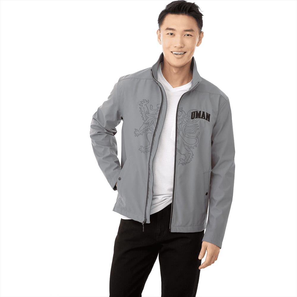 A grey softshell jacket for men with a logo and a stylish design, featuring a zip front and stand-up collar. Karmine Softshell Jacket - Mens - Image 1