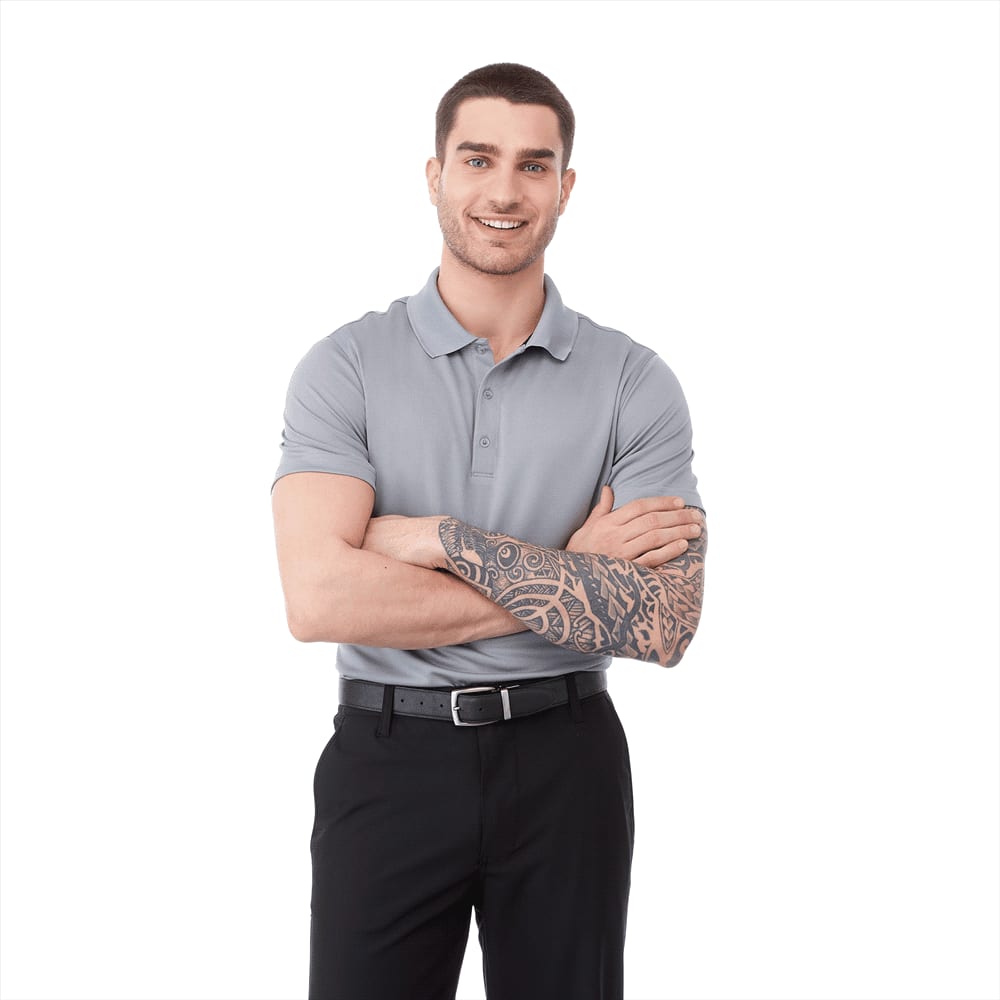 A men's short sleeve polo shirt in light grey, modelled by a smiling man with tattoos, wearing black pants and a belt. Otis Short Sleeve Polo - Mens - Image 1