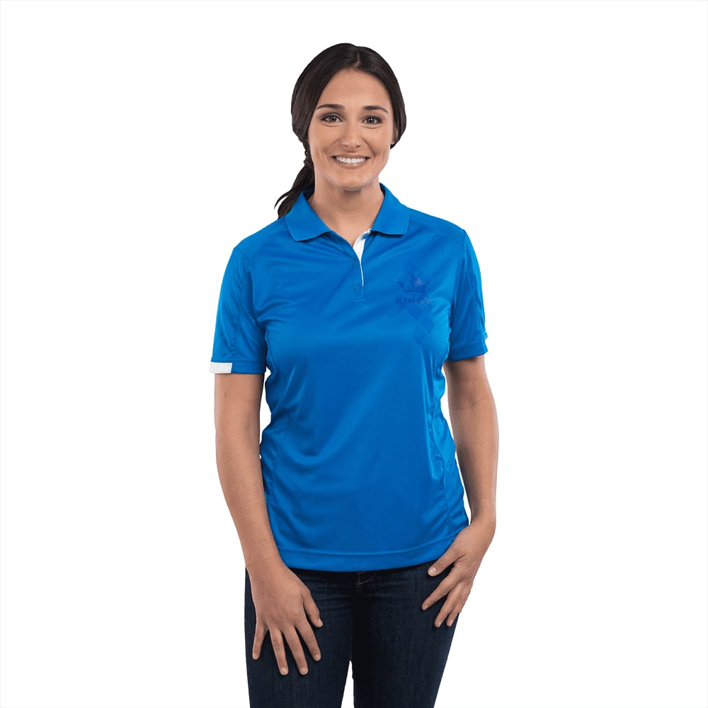 A woman models a short sleeve polo shirt in bright blue, featuring a logo on the front. Kiso Short Sleeve Polo - Womens - Image 1