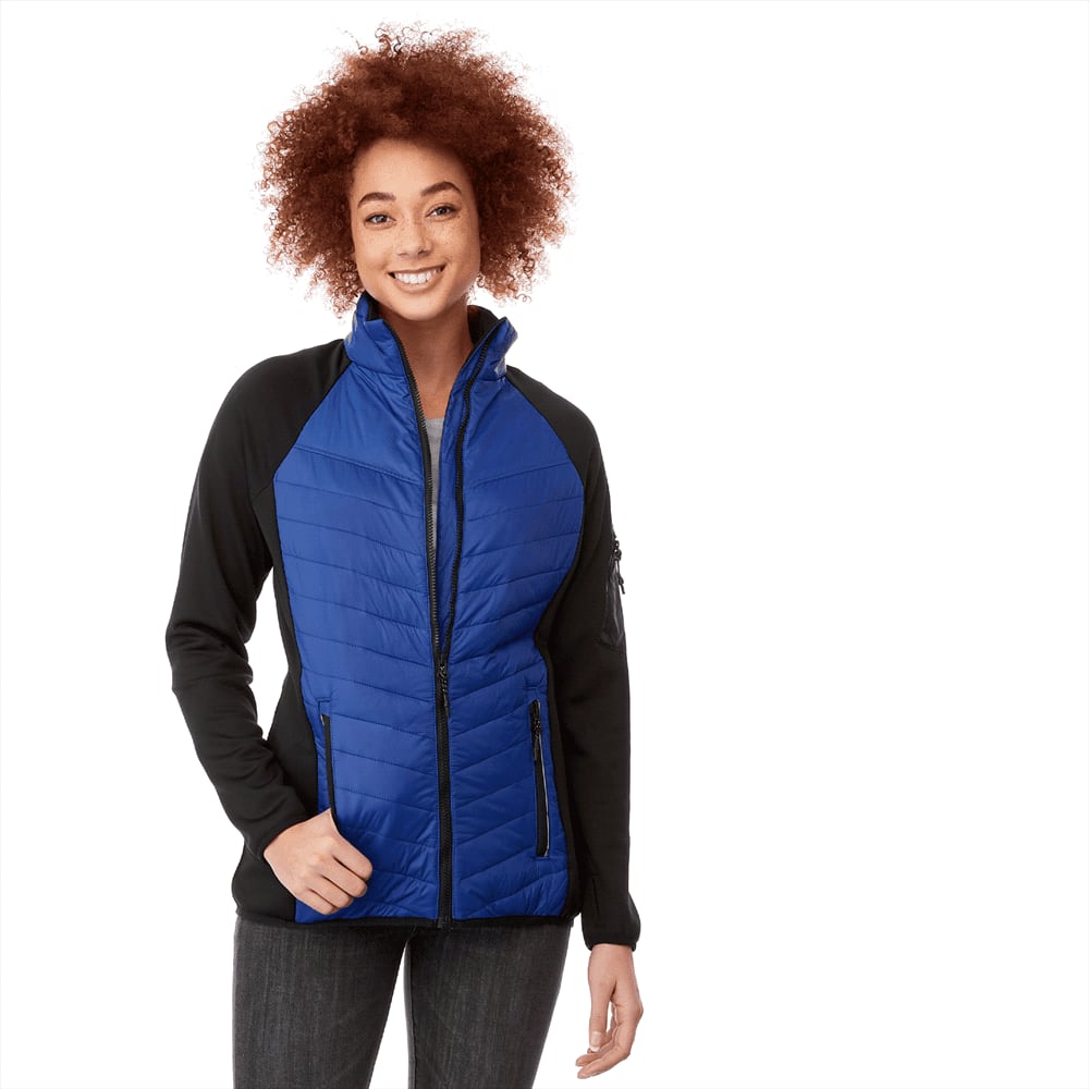 A woman wearing a blue and black insulated jacket, featuring a zip front and side pockets, with a stylish design. Banff Hybrid Insulated Jacket - Womens - Image 1