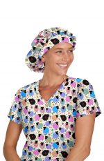 A woman wearing a colourful bouffant cap with a playful pattern, paired with a matching patterned top.