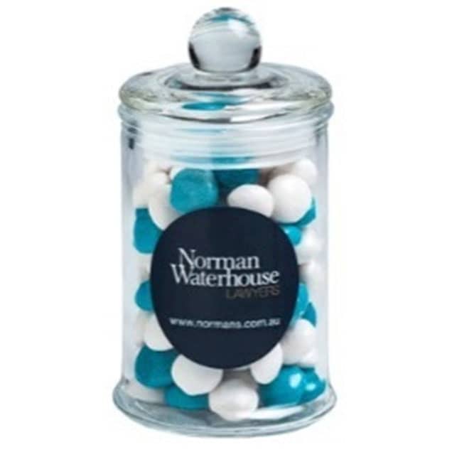 A clear apothecary jar filled with white and blue chewy fruit sweets, topped with a dome lid. Small Apothecary Jar with Chewy Fruits 115g - Image 1