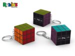 A 3x3 Rubik's Cube keychain in various colours, featuring branding, attached to a metal keyring.
