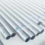 Several silver metallic poles arranged in parallel, featuring small pins and connectors at their ends.