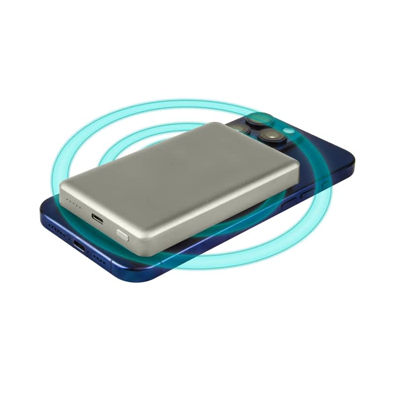 A silver 15W MagSafe wireless power bank placed on a blue smartphone, with a glowing ring indicating wireless charging. Dixon 15W MagSafe Wireless Power Bank - 10,000 mAh (Stock) - Image 1
