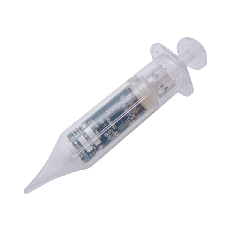 A clear syringe-shaped flash drive with a visible circuit board inside. It features a rounded end and a plunger. Syringe Flash Drive - Image 1