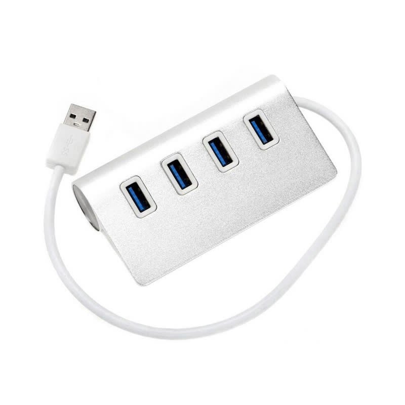 A silver USB hub with four ports and a white cable attached. It has a sleek, modern design. Vanessa 4 Port Hub V3.0 - Image 1