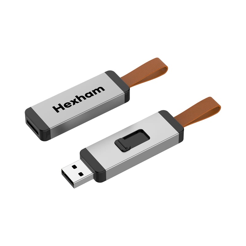 A silver and black Hexham flash drive with a brown strap, featuring a sliding mechanism for connection. Hexham Flash Drive - Image 1
