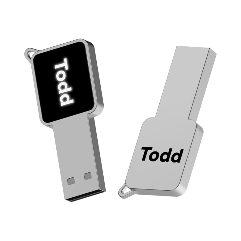 A silver LED flash drive featuring a sleek design with a branding logo. Todd LED Flash Drive - Image 1