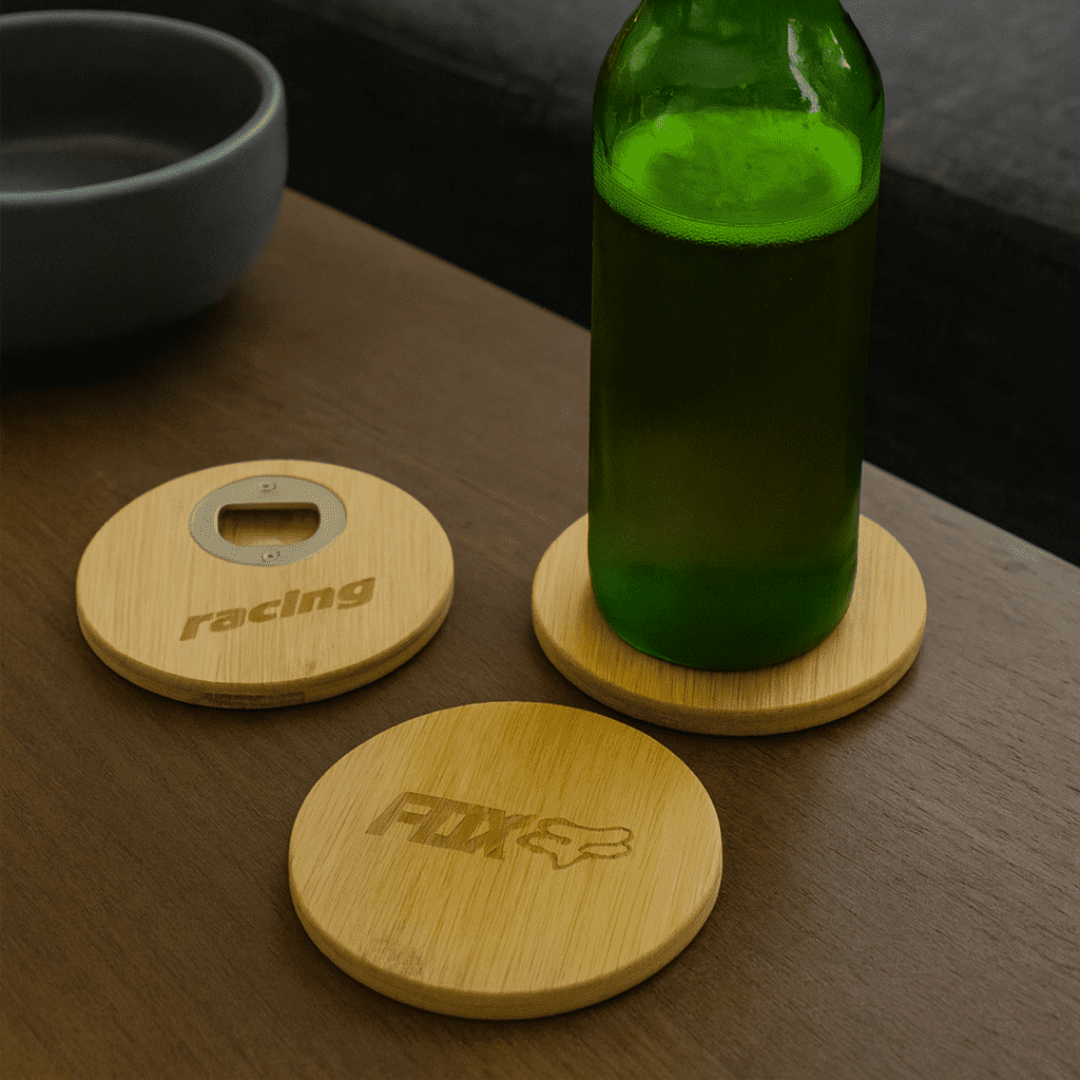 A green drink bottle rests on a round bamboo coaster, alongside two additional bamboo coasters with logos. Round Bamboo Coaster - Image 1