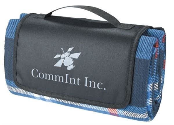 A folded blue picnic rug with a black carrying handle and a logo on the surface. Barrington Picnic Rug - Image 1