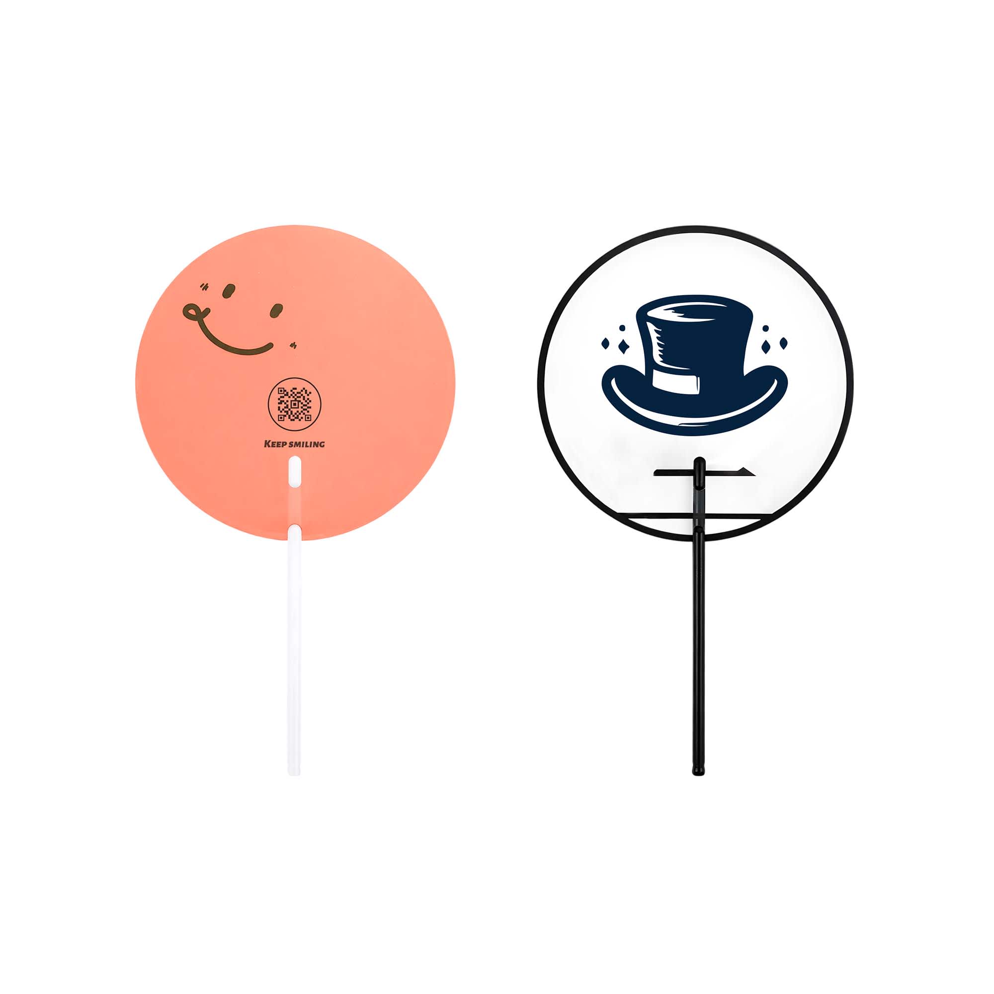 Two custom shape transparent PVC hand fans: one in peach with a smiley face, the other with a top hat design in black and white. Custom Shape Transparent PVC Hand Fan B - Image 1