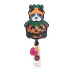 A cute retractable badge featuring a dog in a pumpkin costume with glitter and a logo at the bottom.