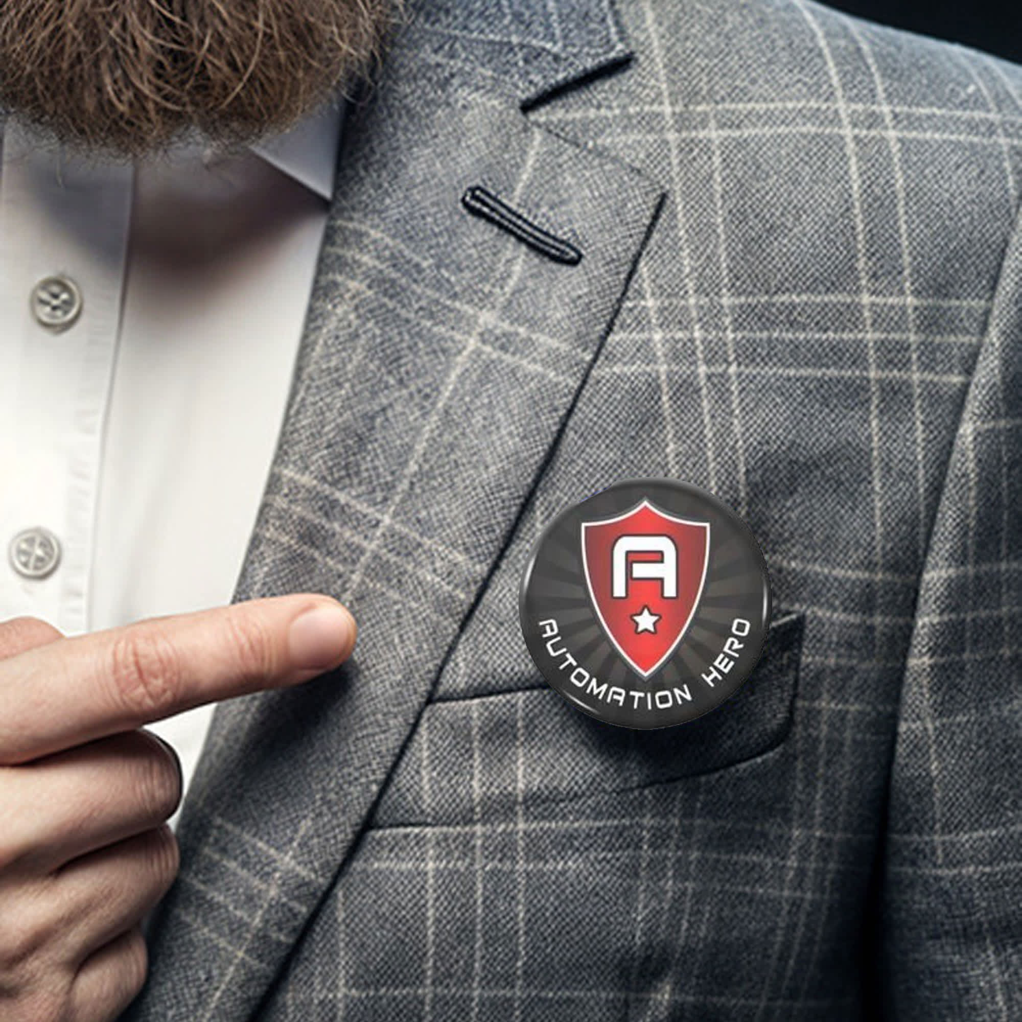 A round button badge, 44mm in size, featuring a shield design, pinned on a grey checked blazer. Button Badge Round 44mm - Image 1