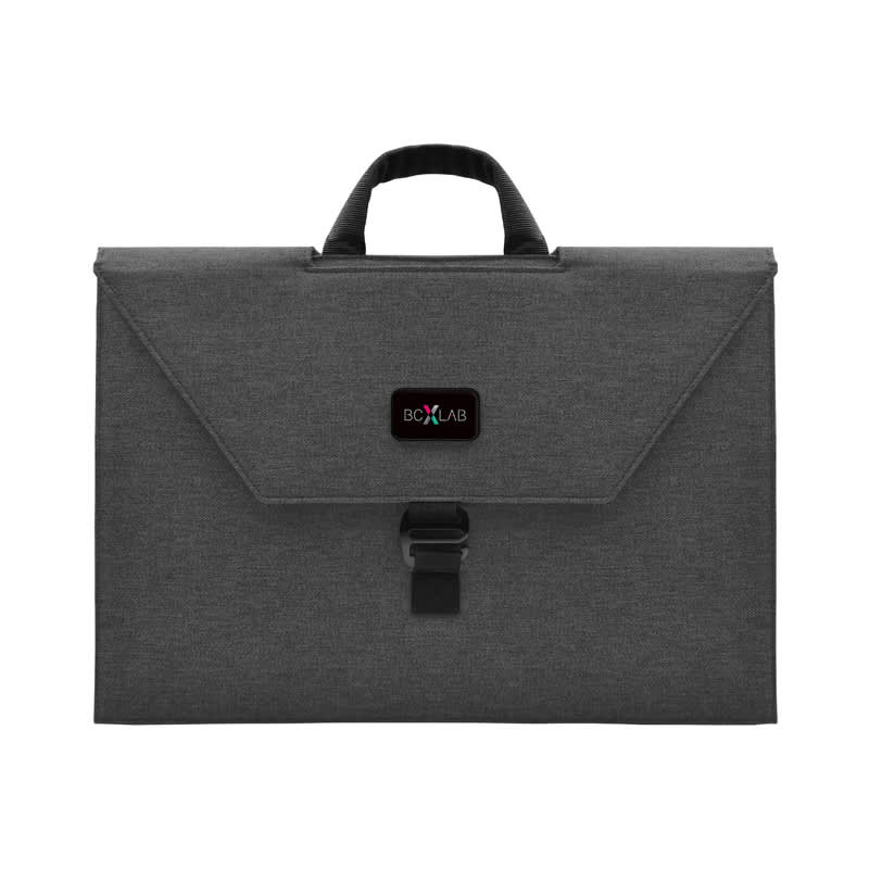 A grey laptop bag with a handle and a flap closure. It features a branding logo on the front. Specter Workspace - Image 1