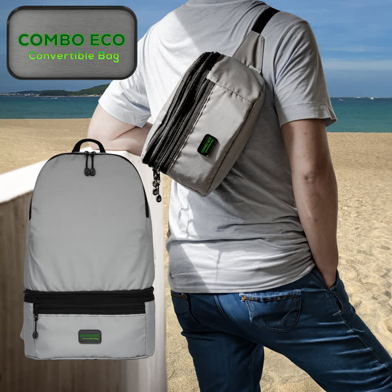 A grey, convertible bum bag is worn over the shoulder, alongside a grey backpack, against a beach backdrop. Combo Eco Convertible Bag - Image 1