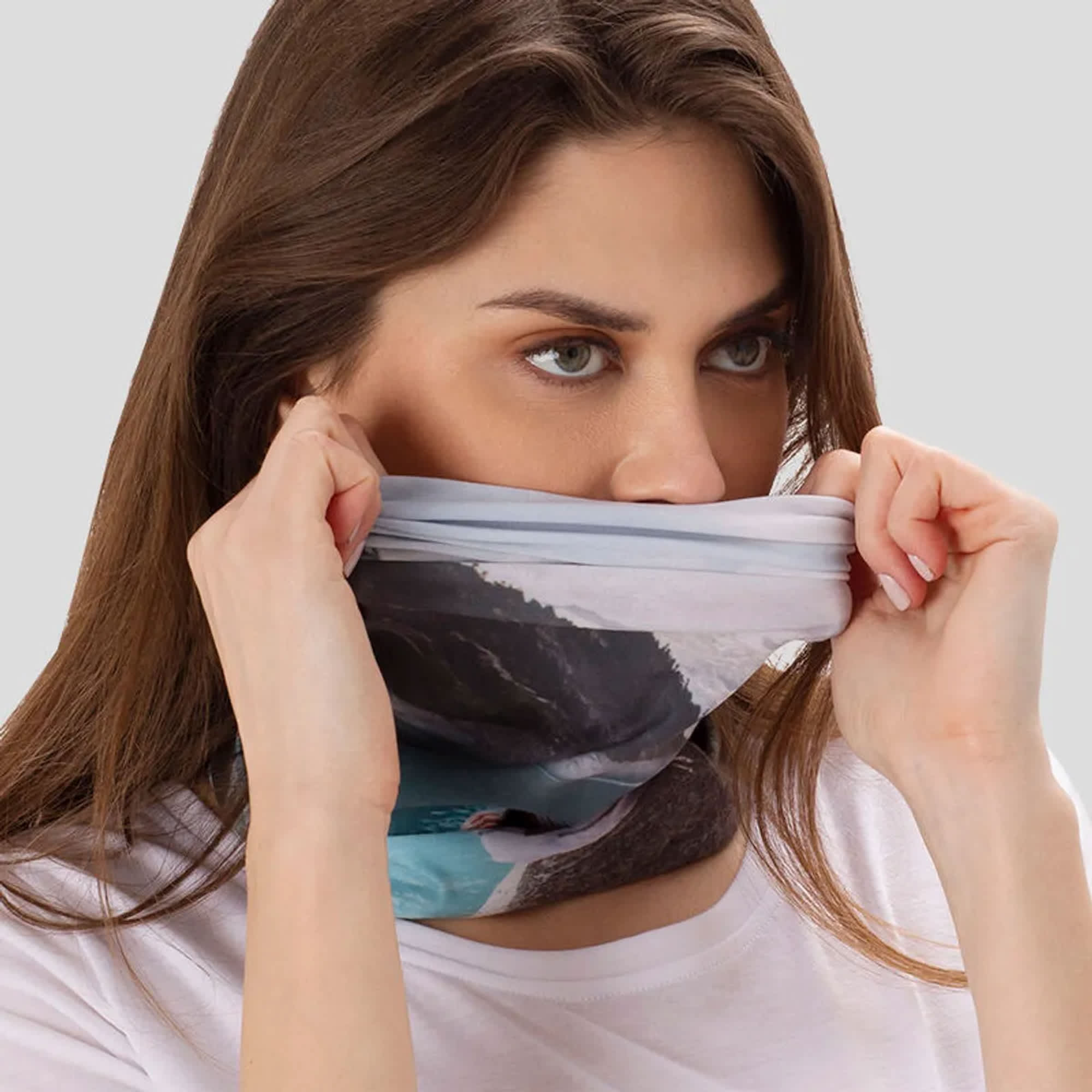 A large tubular bandana in shades of blue and grey, being worn around a woman's neck. It features a scenic design. Tubular Bandana – Adult Large - Image 1