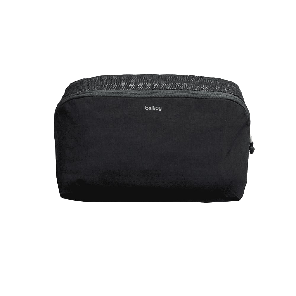 A black packing cube with a mesh top and a logo, designed for organising travel essentials. Bellroy Lite Packing Cube 6L - Image 1