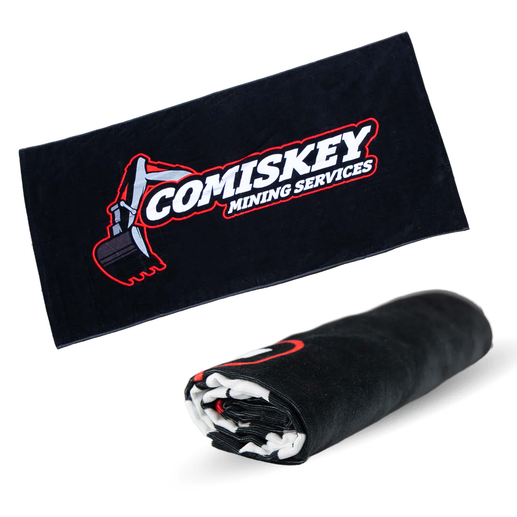 A black beach towel featuring a logo, measuring 75cm x 150cm, prominently displayed when rolled out. 350G Porto Cotton Beach 75cmX150cm - Image 1